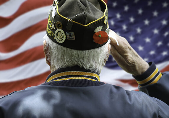 A veteran saluting an American flag